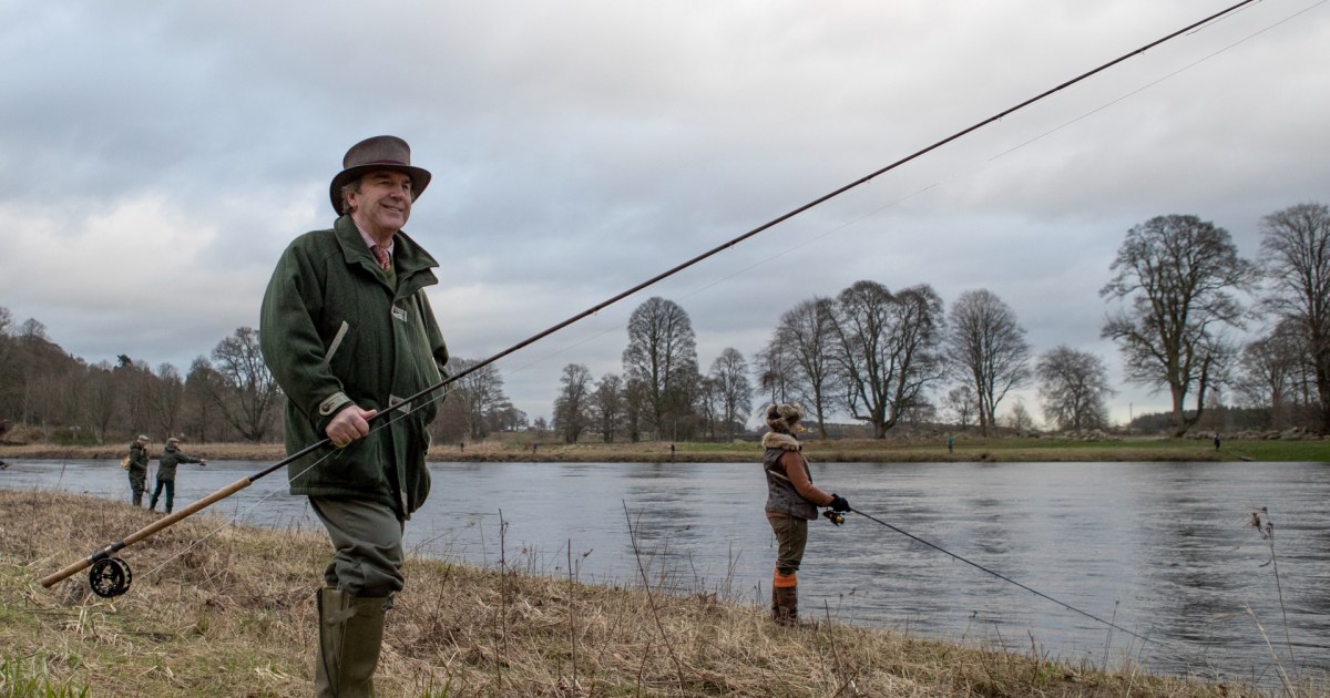 Man Throwing And Pulling In Fishing Net by David H. Wells