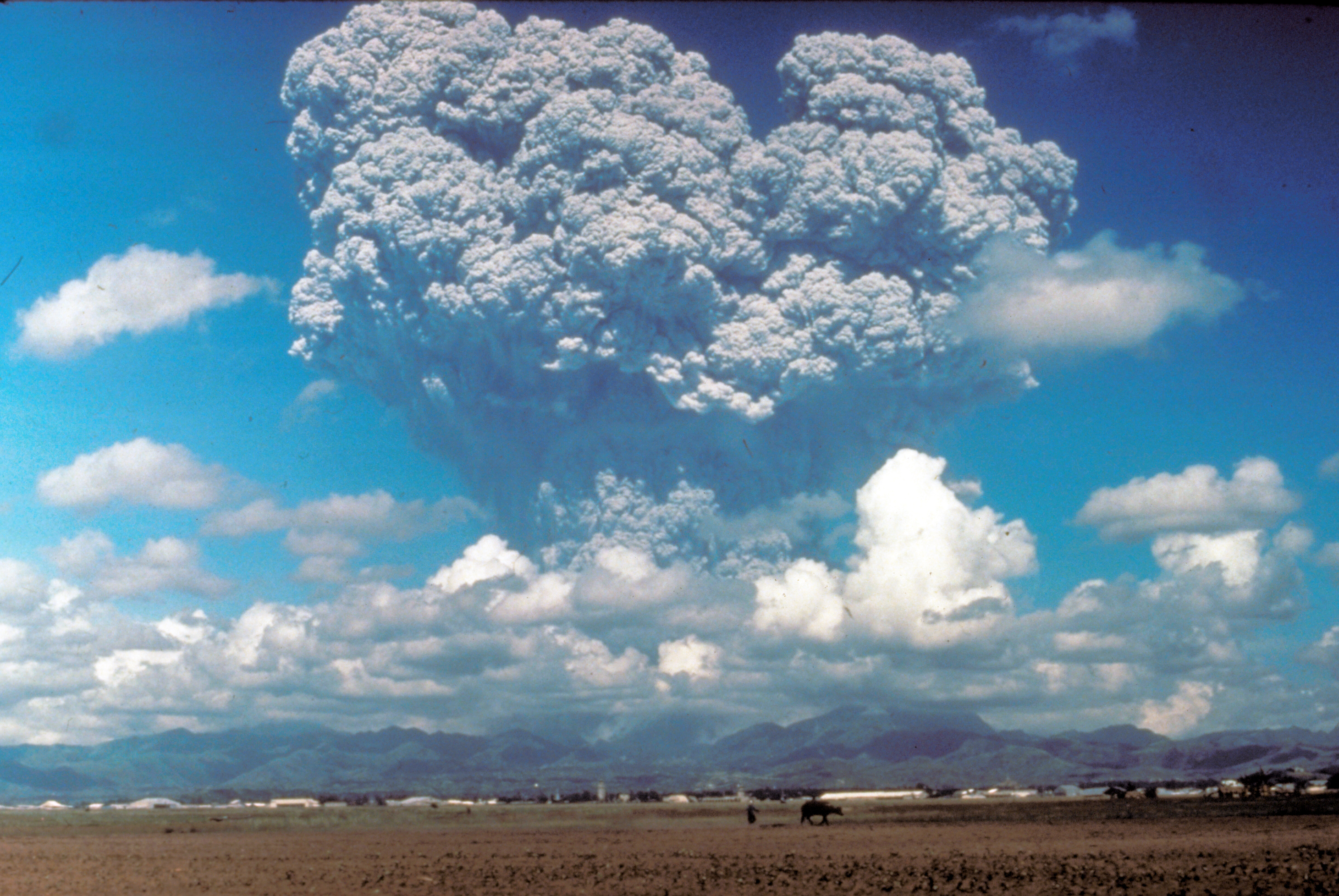 Volcanic eruption with large smoke plume.
