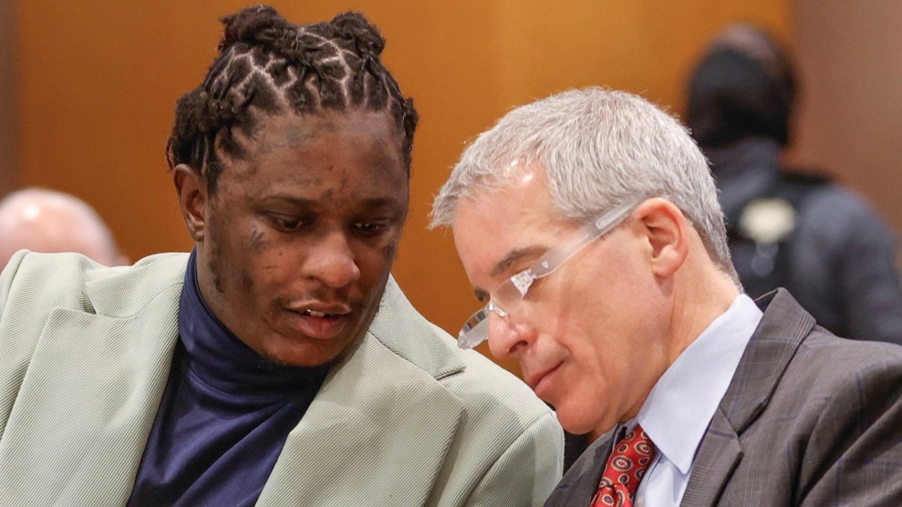 Image of Young Thug talking with his lawyer Brian Steel in court.