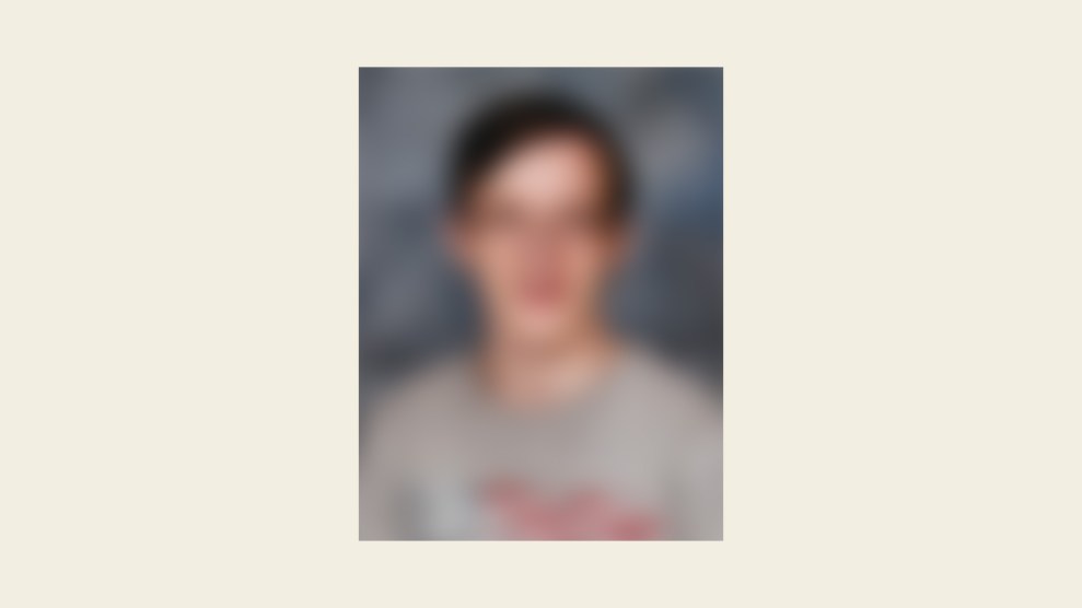 A blurred portrait of a person against a neutral background. The image lacks clear details, making it difficult to distinguish specific facial features or clothing.