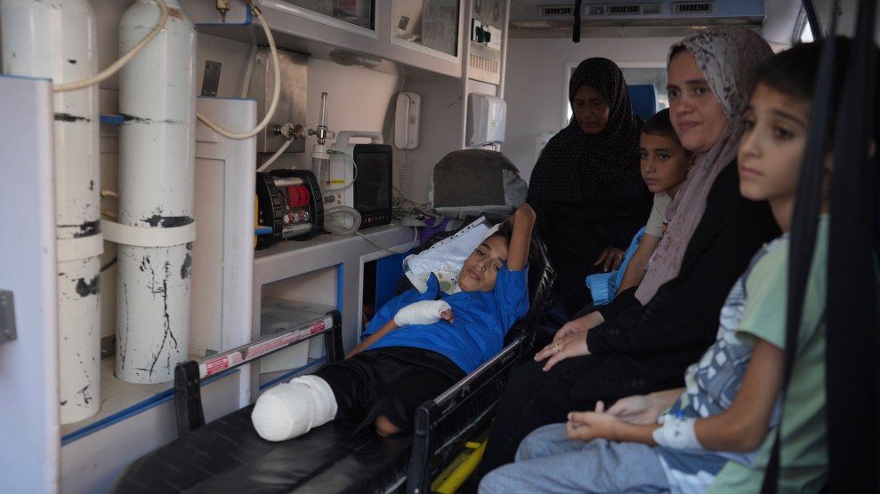 A Palestinian child amputee in an ambulance with three other people