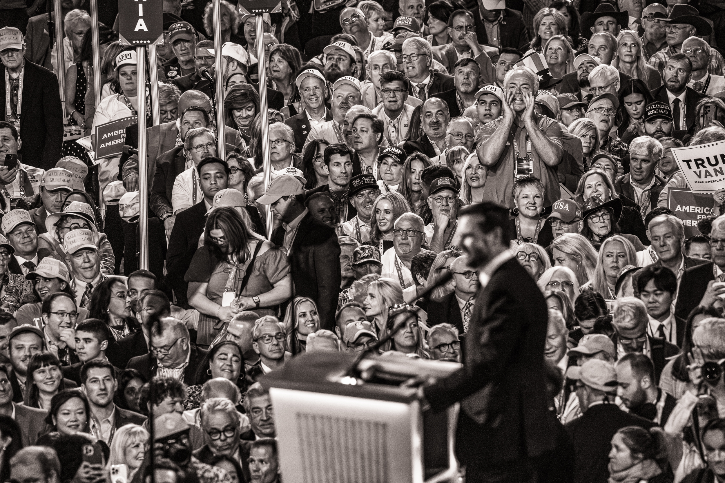 Black-and-white photo of a crowd of people looking adoringly at J.D. Vance, speaking to the crowd.