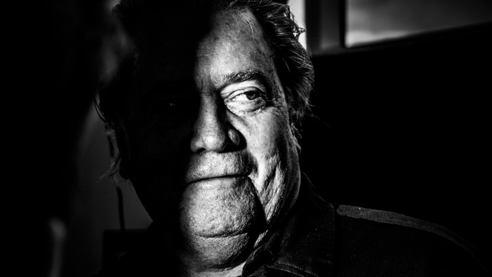 Black and white photo of Steve Bannon, in shadow.