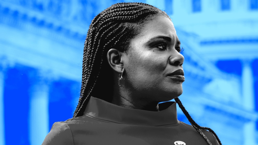 Congresswoman Cori Bush looks stoically to her left on the steps of the US Capitol Building