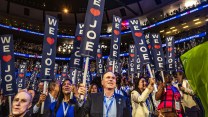 Delegates at the DNC hold We Love Joe signs on the first night of the convention.