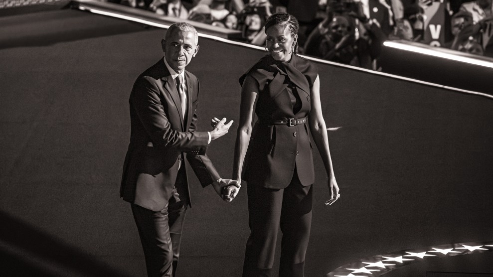 Black and white photo of Barack Obama holding hands with and pointing at Michelle Obama.