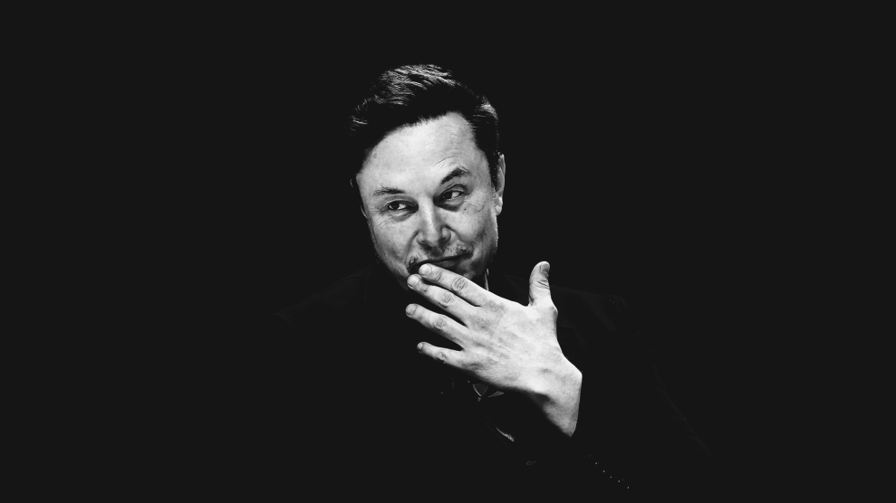 Elon Musk in black and white on a black background. His left hand is up to his mouth, as he appears to hold back a grin.