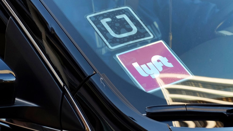 A photo of a black car with Uber and Lyft stickers
