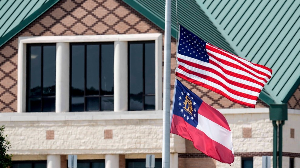 Flags fly at half-staff outside Apalachee High School in Winder, Georgia.