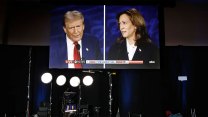 A TV screen shows an image of Kamala Harris and Donald Trump during the Presidential debate