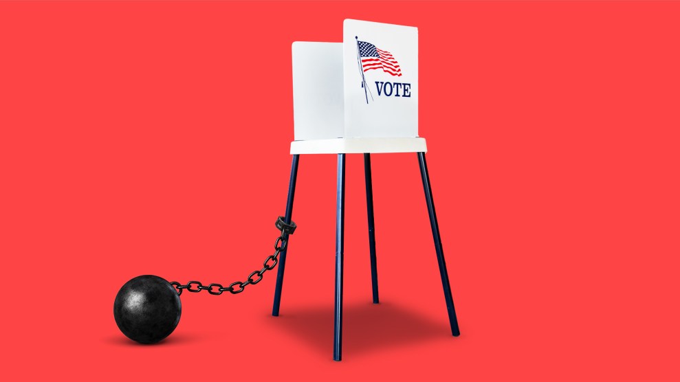 A voting booth with a ball and chain attached to one of the legs of the structure.