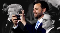 A photo of JD Vance smiling as he looks at his phone, as he stands between Donald Trump and Representative Mike Johnson.