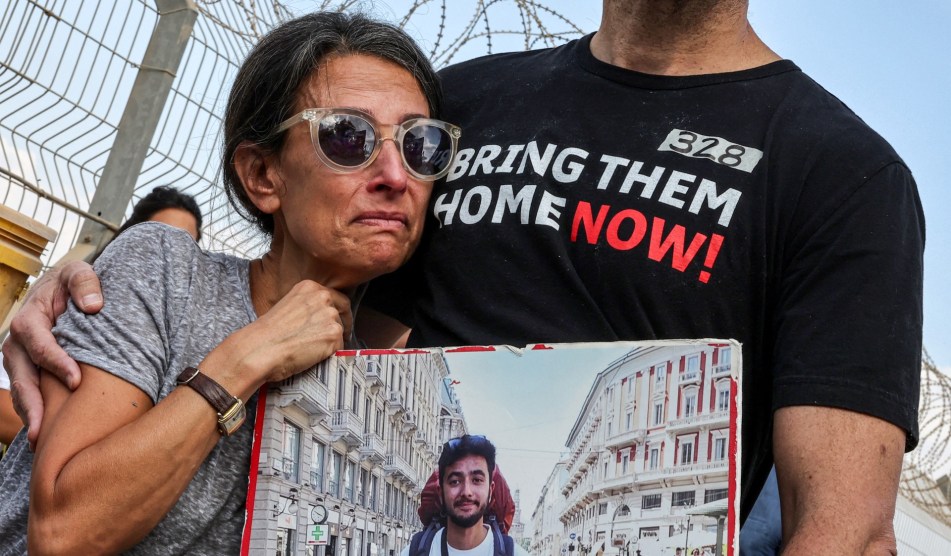 A photo of Rachel Goldberg-Polin holding a picture of her son, Hersh, at a rally to free hostages