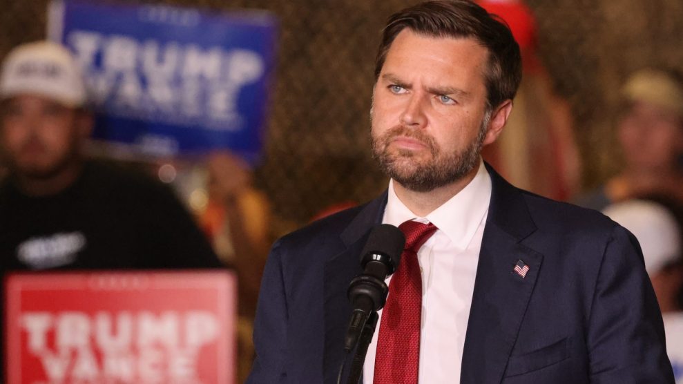 Vice presidential candidate JD Vance, a white man in a blue suit, addresses a Trump rally.