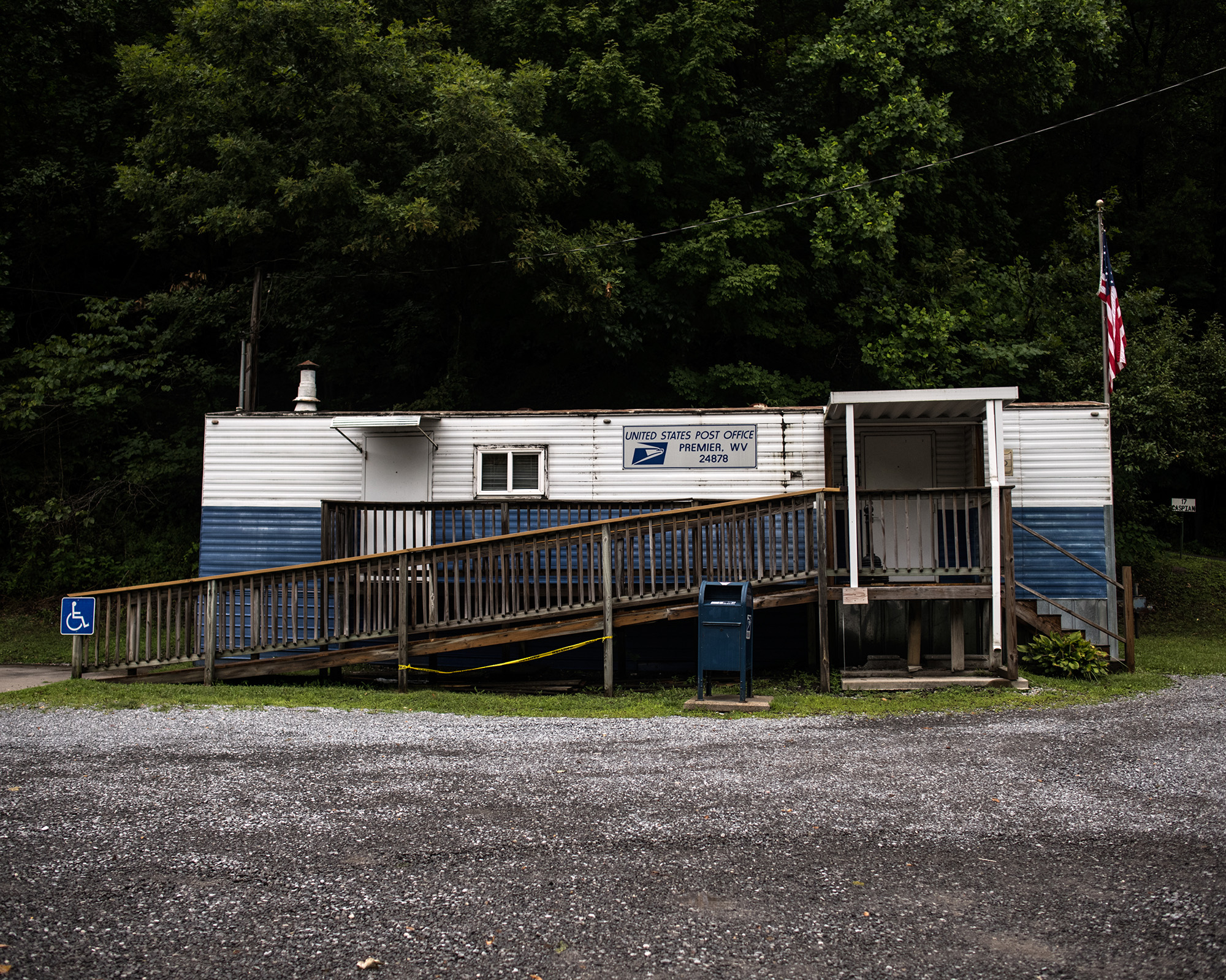 A small rural post office with an American flag out front.