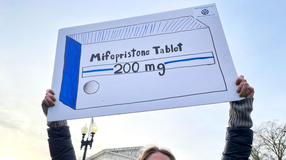 A supporter of abortion rights holds a sign in support of access to medication.