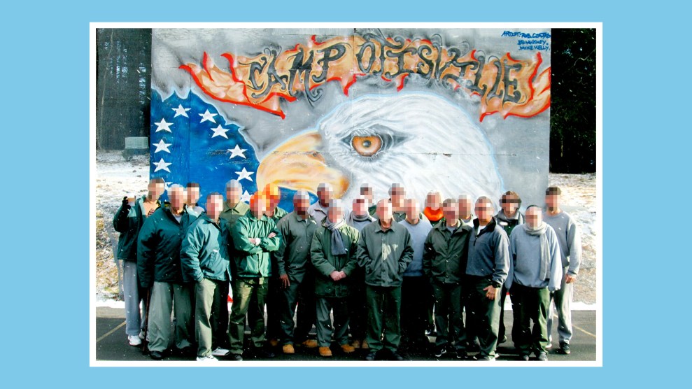 A group photo of incarcerated men standing in front of a mural that reads "Camp Ovisville"