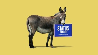 A donkey holding a campaign sign for "STATUS QUO" in its mouth