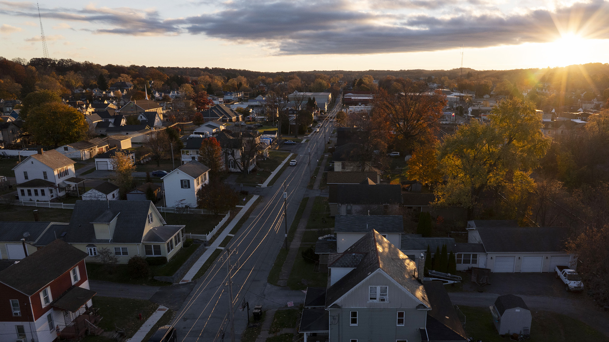 Aerial view of city with sunrising in background.