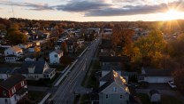 Aerial view of city with sunrising in background.