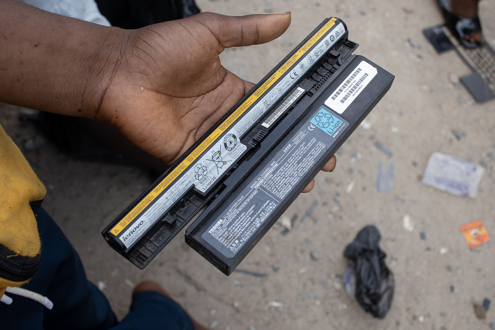 Man holding a laptop battery.