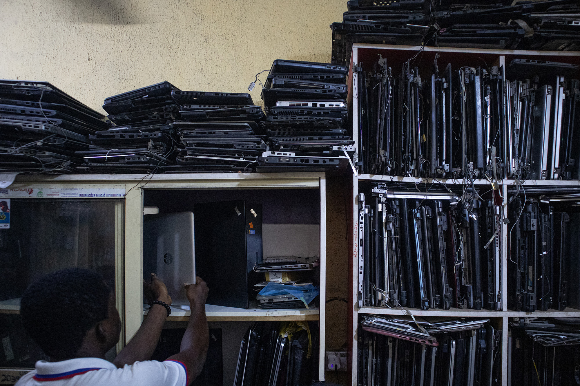 Shelves full of old, used laptop computers.