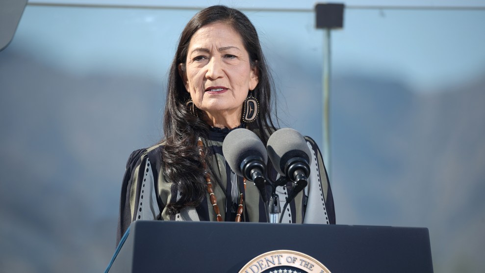 A photo of a woman with black hair on a lecturn.