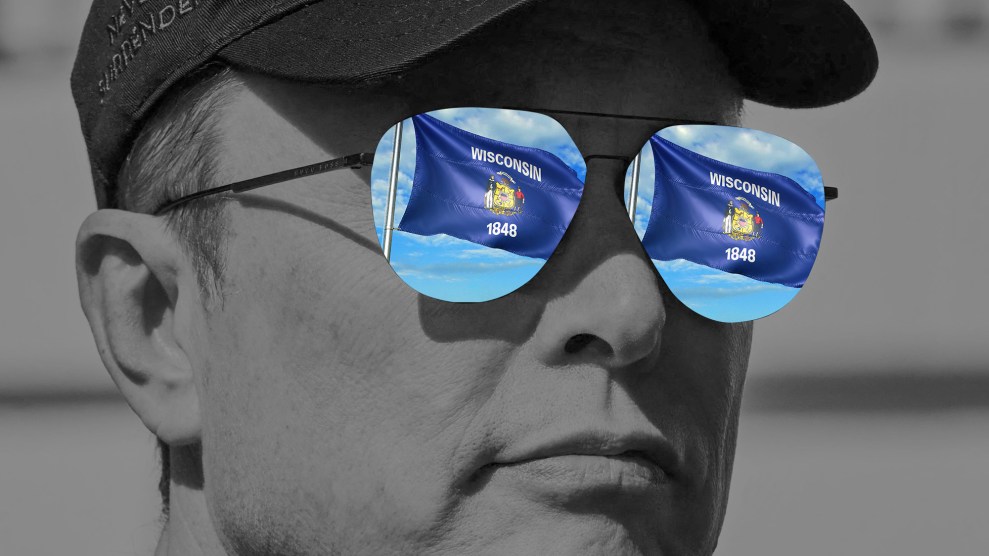 A black-and-white close-up photo illustration of Elon Musk wearing a cap and reflective aviator sunglasses. The lenses of the sunglasses display a full-color image of two Wisconsin state flags waving against a bright blue sky.