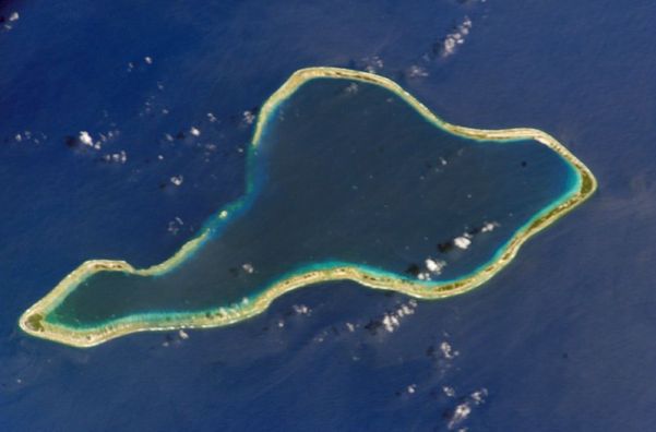 Top: Moruroa Atoll. Bottom: Fangataufa Atoll, French Polynesia, sites of French nuclear tests. The dark blue waters in the upper lagoon of Fangataufa mark the deep crater created by bomb explosions. Credit: NASA, via Wikimedia Commons.