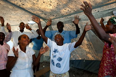 A service in a makeshift church found in the 55,000-person tent camp on the grounds of the Petionville golf club.