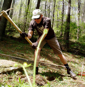 Actionshot--The author helps build a fence for the chicken yard, spring 2011. 