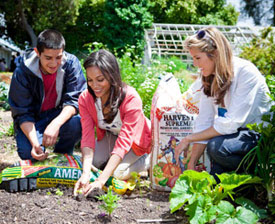 Rosario Dawson poses with a sack of Kellogg Amend, a fertilizer composed of sewage sludge