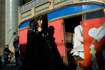 A woman walks in front of the Great Mosque in central Herat.