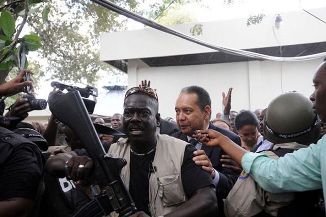 Baby Doc being led into the courthouse in Port Au Prince.