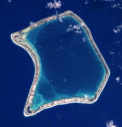 Top: Moruroa Atoll. Bottom: Fangataufa Atoll, French Polynesia, sites of French nuclear tests. The dark blue waters in the upper lagoon of Fangataufa mark the deep crater created by bomb explosions. Credit for both: NASA, via Wikimedia Commons.