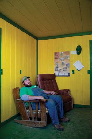 Casey Smith in the John Deere-themed office on his dad's farm