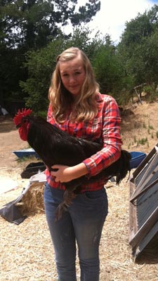 Kendall Post, 14, holds one of her roosters.