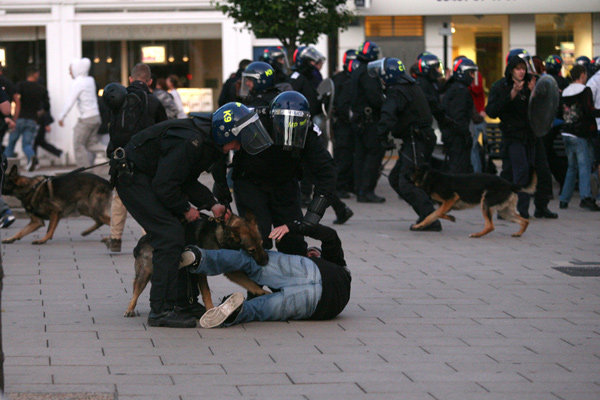 A police dog attacks a rioting suspect in Enfield.: National News/ZUMA