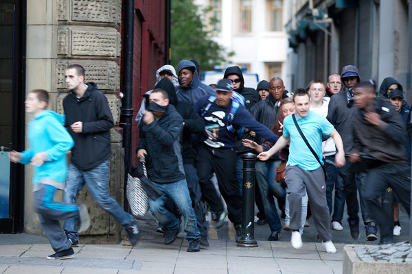 Young rioters run through the streets of Manchester.: Joel Goodman/ZUMA