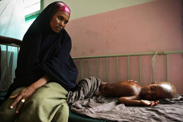 A mother and her starving and dehydrated child lying at Banadir Hospital in Mogadishu, where more than 500,000 displaced Somalis seek aid. /Stuart Price/UN/Flickr
