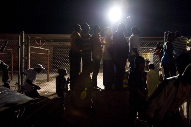 Supporters wait for a glimpse of Jean-Claude Duvalier at the Port Au Prince airport.