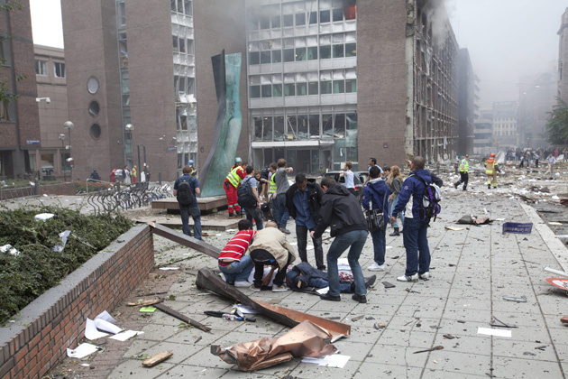 OSLO, NORWAY - Bystanders care for victims of a bomb blast that rocked government and media buildings here on Friday.: Scanpix/Zuma