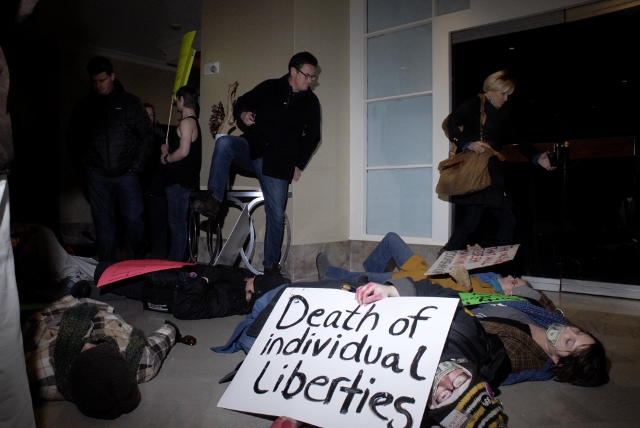 Joe Scarborough, host of MSNBC's Morning Joes, steps over Occupy protesters staging a die-in at a Des Moines hotel.: Joe Scott