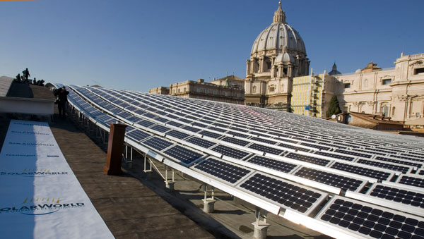 St. Peter's Basilica is seen in the background of a solar panel set up on the roof of the Paul VI Hall at the Vatican. Photo: Evandro Inetti/Zumapress.com